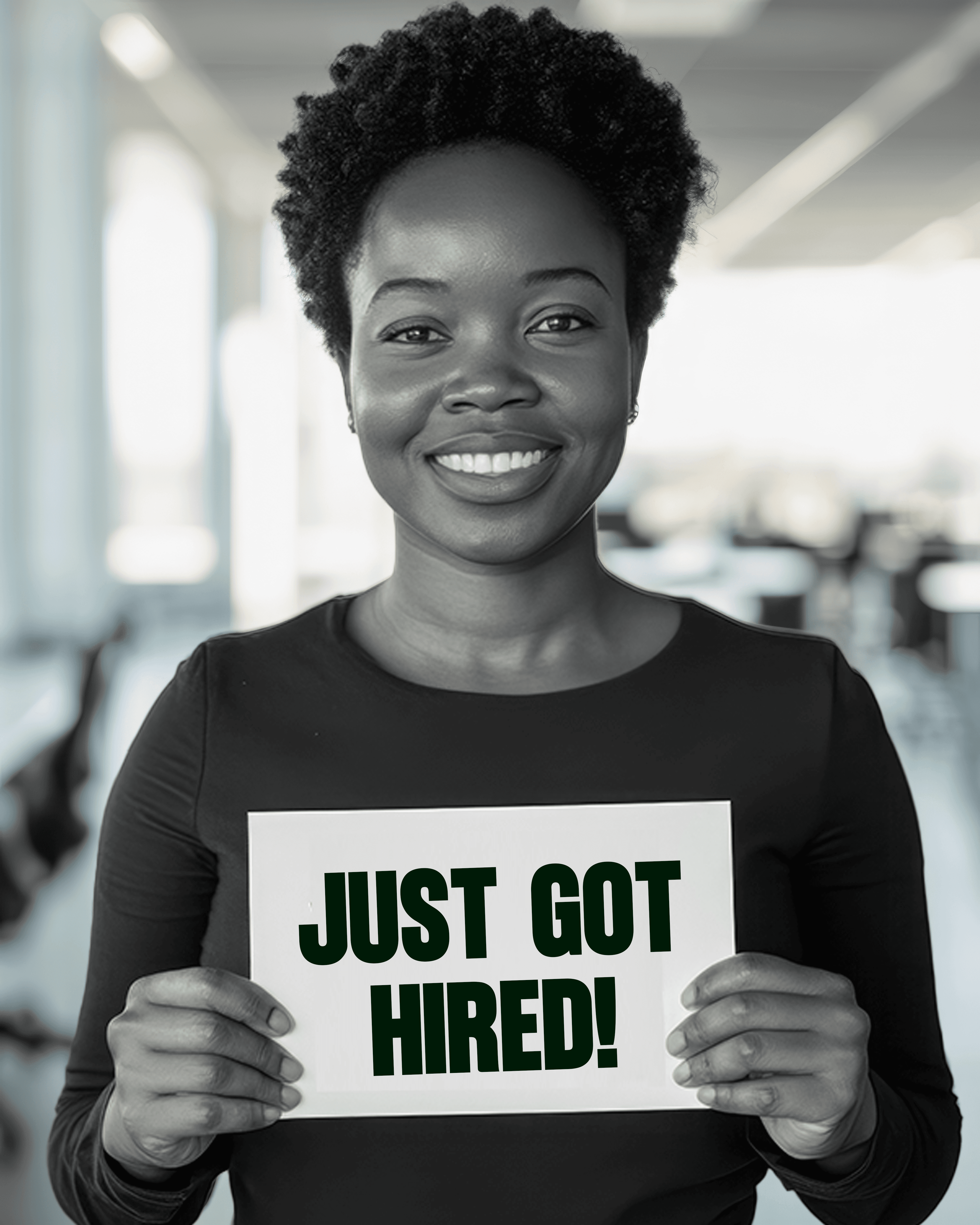 A DotNexxt mentee holding a “Just got hired!” sign
